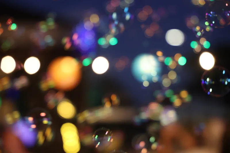 Warm party lights out of focus at night