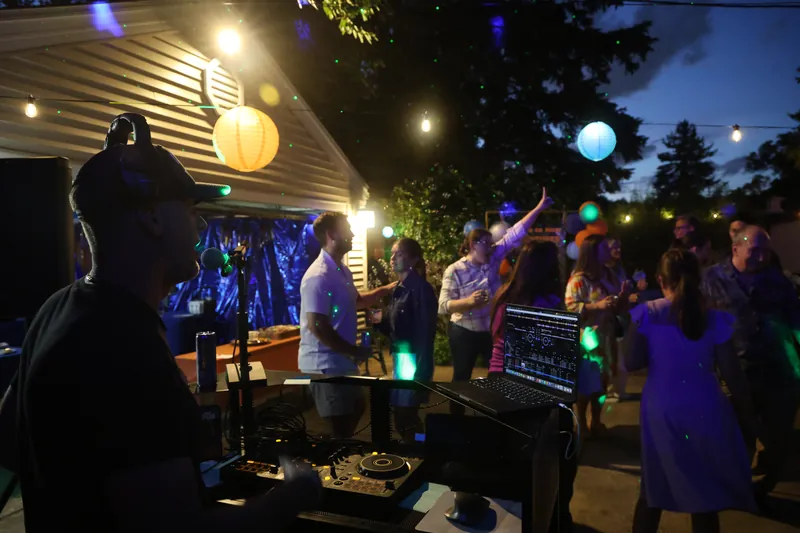 An evening crowd on the dance floor lit by hanging lanterns